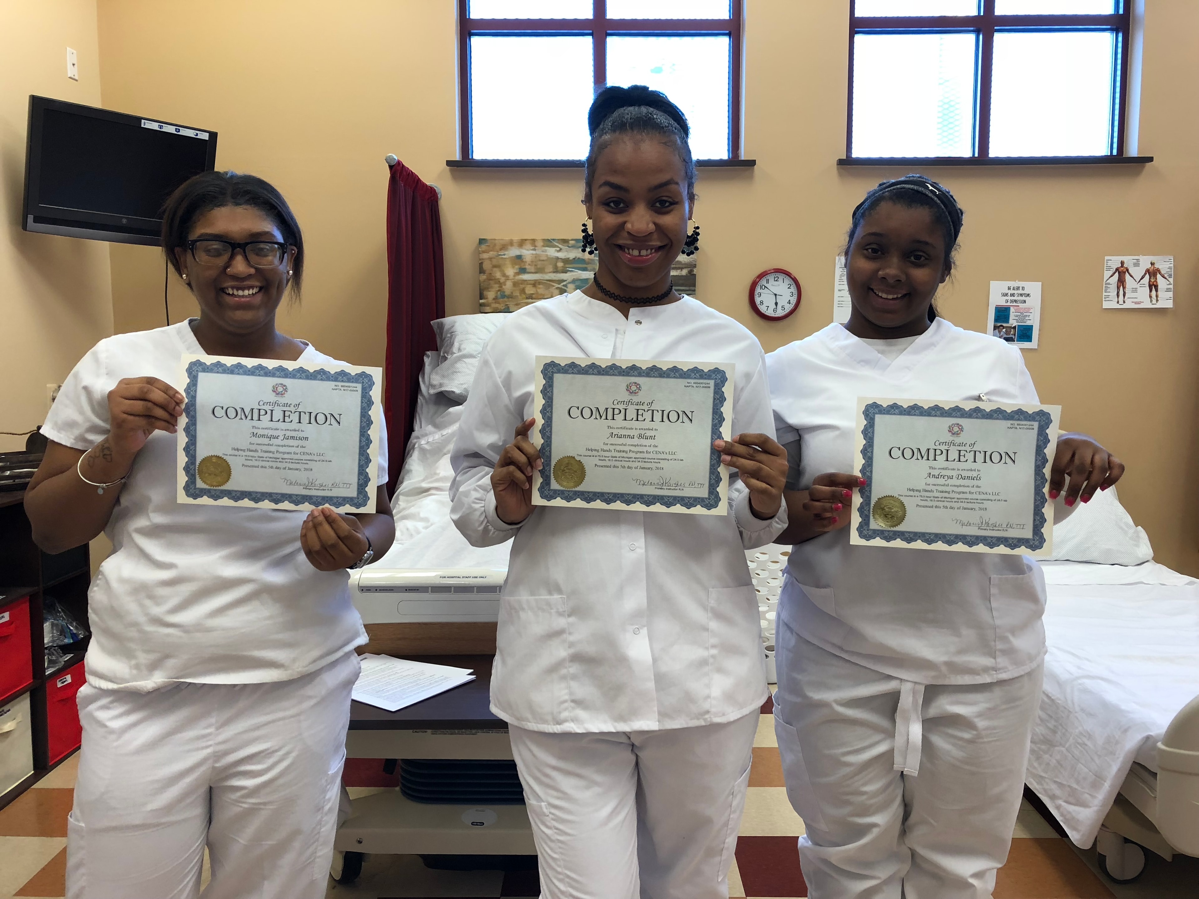 Helping Hands CNA graduates holding certificates of completion